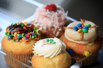 Variety of delicious cupcakes in a box from a pastry shop
