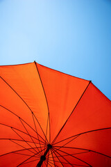 orange parasol under blue sky © Stockhausen
