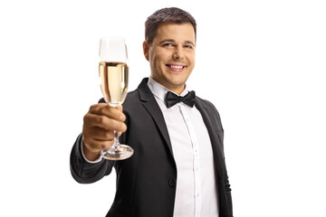 Elegant young man in a suit and bow tie toasting with a glass of sparkling wine