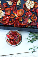 sun-dried tomatoes. Sun-dried tomatoes with herbs and garlic on a wooden background. - 436735651