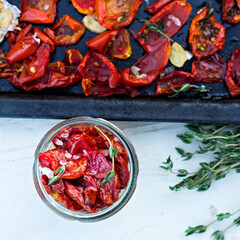 sun-dried tomatoes. Sun-dried tomatoes with herbs and garlic on a wooden background. - 436735683