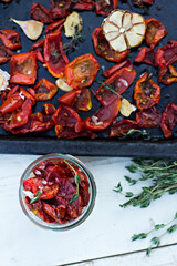 sun-dried tomatoes. Sun-dried tomatoes with herbs and garlic on a wooden background. - 436735693