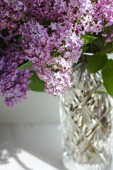 Vase with a bouquet of lilacs on the window. - 436736292