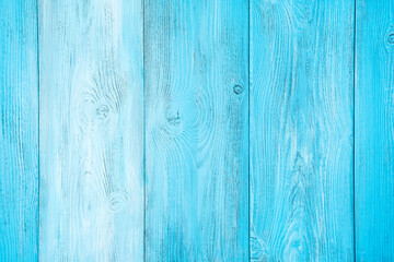 Fototapeta na wymiar Natural wooden background painted in different tones of light blue color. Horizontal view.