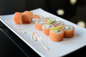 Sushi rolls on white dish. Japanese food.
