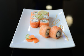 Sushi rolls on white dish. Japanese food.