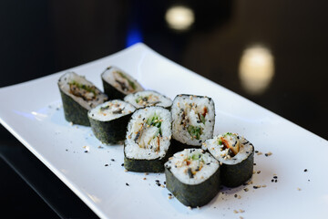 Sushi rolls on white dish. Japanese food.