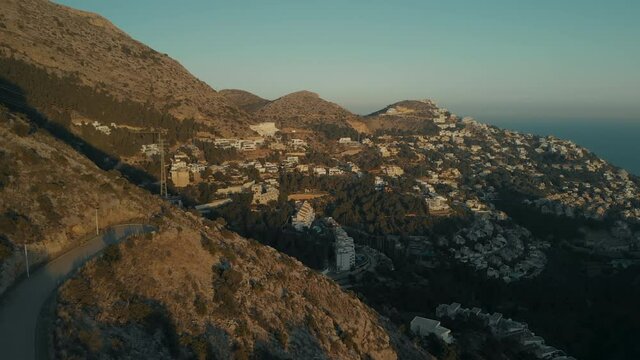 Beautiful cinematic footage of residential neighbourhood on side of mountain in touristic and popular area in southern Spain. Summer holiday vacation real estate in exclusive gated community