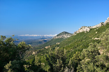 Fototapeta na wymiar Panoramic Mountain Landscape with layered by blue sky over the mountain ranges, Sardinia, Orosei region.