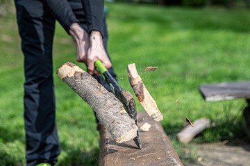 Flying pieces of wood. Man is chopping wood with axe. Frozen moment.