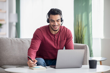 Happy arab guy attending online training from home