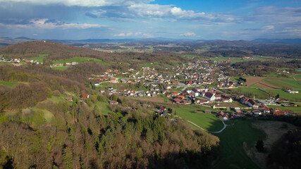 Fototapeta na wymiar AERIAL: Flying towards the quiet rural town of Sticna and its famous monastery.