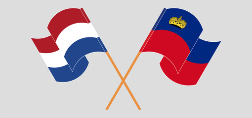 Crossed and waving flags of the Netherlands and Liechtenstein