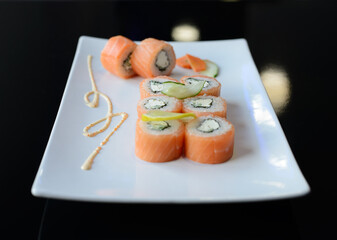 Sushi rolls on white dish. Japanese food.