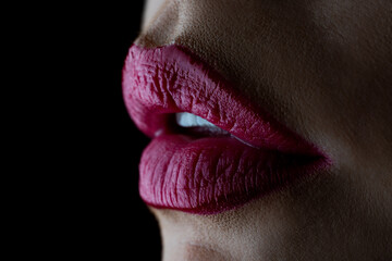 Red lips close-up. Classic red lips on black background. Womans red lips with cope space.