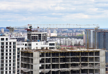 Tower crane during construction of a residential building. Cranes on formworks. Construction the building or multi-storey homes, Arial view. Real Estate and Renovation concept. Housing project