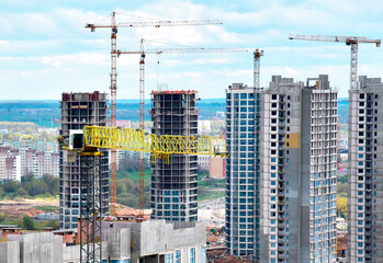 Tower crane during construction of a residential building. Cranes on formworks. Construction the building or multi-storey homes, Arial view. Real Estate and Renovation concept. Housing project