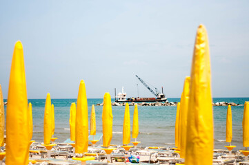 closed beaches with a ship at work in the distance