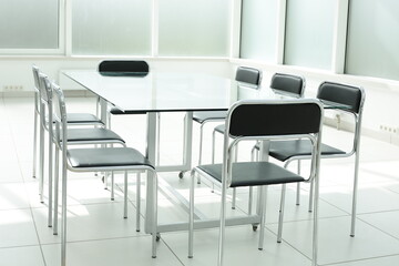 Glass table and chairs in a bright office space