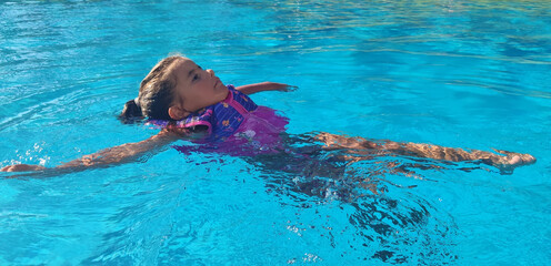 Little girl swimming in the pool