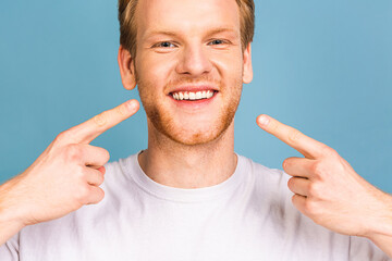 Detailed image of young man smiling with perfect white teeth. Healthy concept. Close-up.