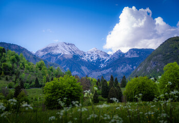Clouds over mountains around the Bohinj Lake in Slovenia at late afternoon