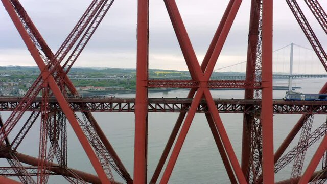 A Train Crossing a Red Bridge in Scotland