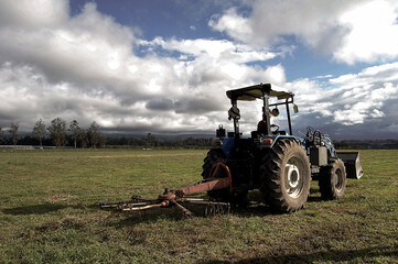 tractor plowing the land in an afternoon