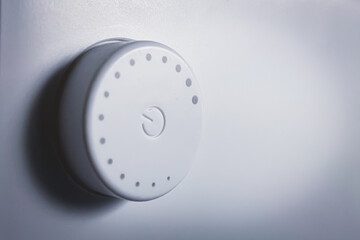 Close up Rotary power button on white. Side view of round power button.