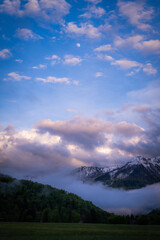 Mountains buried in fog around Lake Bohinj in Slovenia during colorful sunset