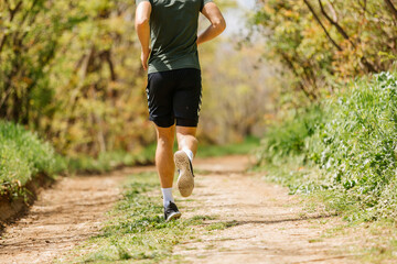 Sport man running. Portrait of runner man jogging in park. Sport workout outdoor. Athlete training run exercise