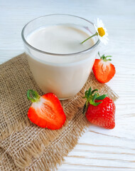 fresh milk, strawberries on wooden background
