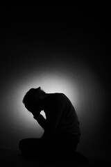 Silhouette of depressed boy