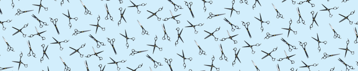 Background of black scissors. professional hairdresser black scissors isolated on blue. Black...