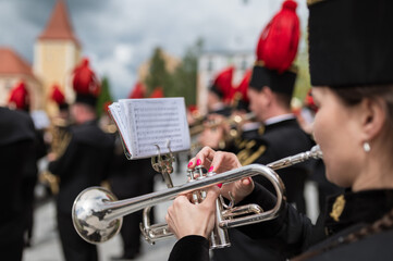 Woman playing the trumpet in the background mining orchestra.