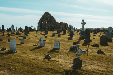 Large cemetery with gravestones on a sunny meadow