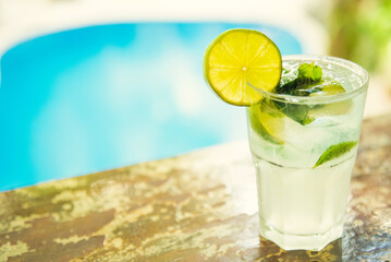 Colorful tropical cocktails on wooden bar. Mixology in pool holiday setting. Caribbean cocktails. Colorful cocktails in caribbean bar hotel.