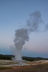 Old Faithful geyser eruption in Yellowstone National Park, Wyoming, USA