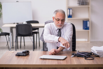 Aged male employee suffering at workplace
