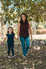 Mother and daughter in the park with their big dog