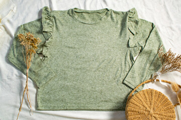 water green t-shirt on white canvas with decorative objects