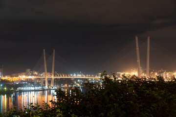 Fototapeta premium Night city landscape with a view of the Golden Bridge. Vladivostok