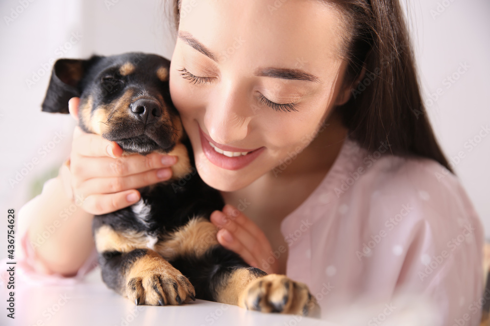 Canvas Prints Woman with cute puppy indoors. Lovely pet