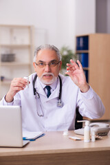 Experienced male doctor working in the clinic