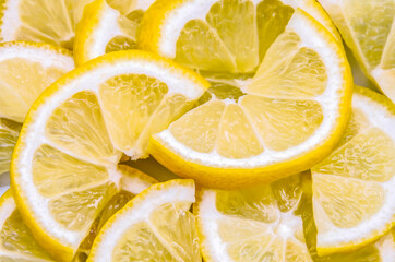 Ripe lemon wedges cut in half - 436755072