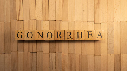 The word gonorrhea created from wooden cubes. Health and life - obrazy, fototapety, plakaty