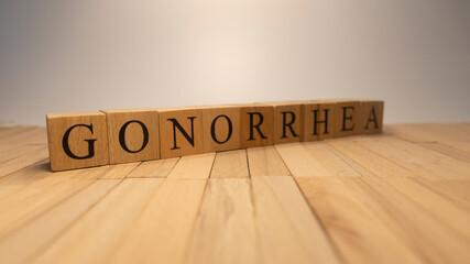 The word gonorrhea created from wooden cubes. Health and life