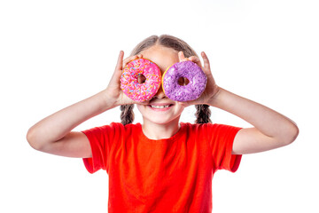 Cute little european girl with pigtails smiling and looking through two colorful donuts on her eyes...