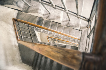 Old spiral staircase with wooden railing	