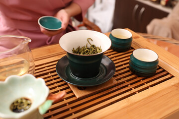 Obraz na płótnie Canvas Traditional tea ceremony. Master near tools and tray, closeup